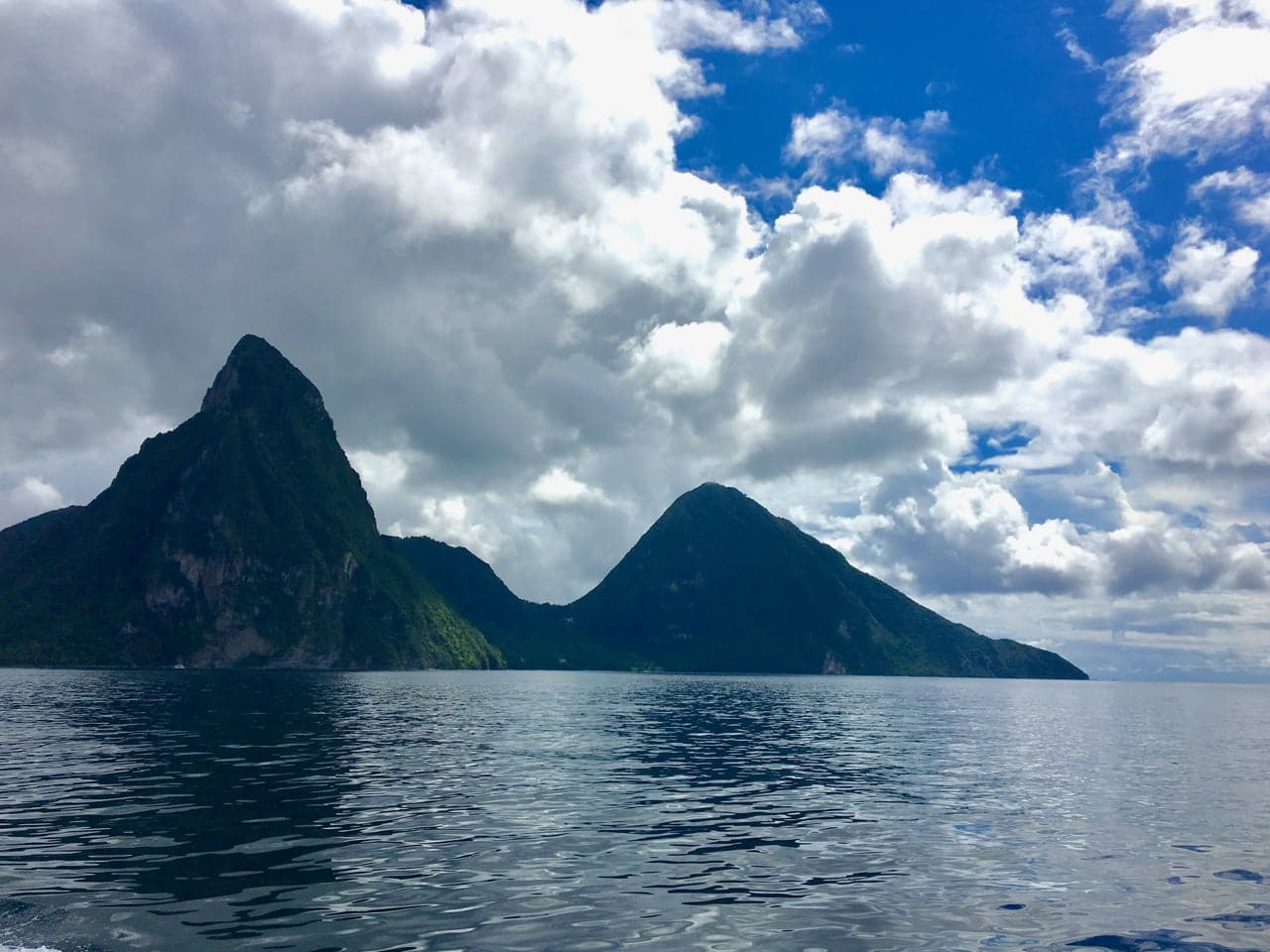 The Pitons rise dramatically off the coast of Saint Lucia, one of the greenest islands visited on the Southern Caribbean Cruise.