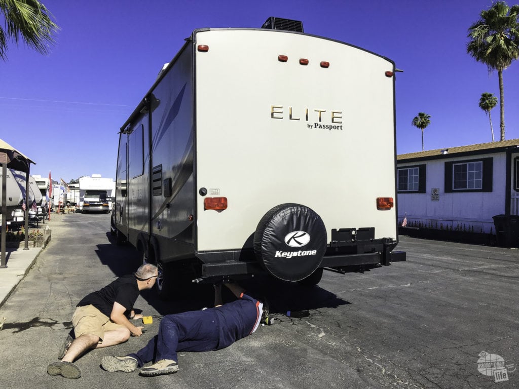 Grant assisting James while he provides RV service.
