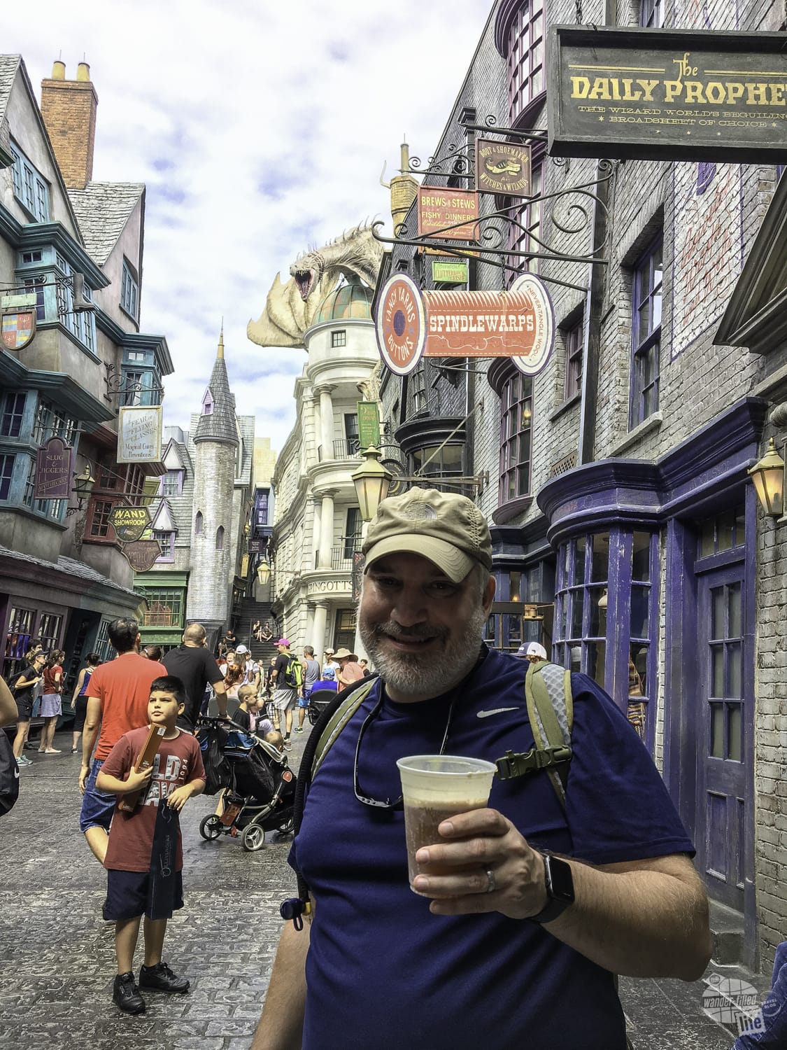 Grant trying a butterbeer in Diagon Alley.