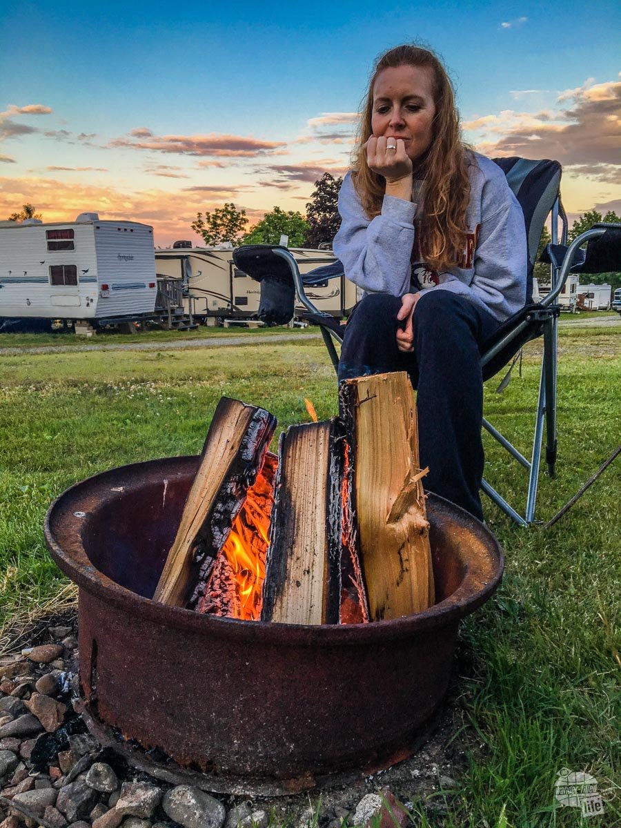 Bonnie enjoying the warmth of a campfire at our campground.