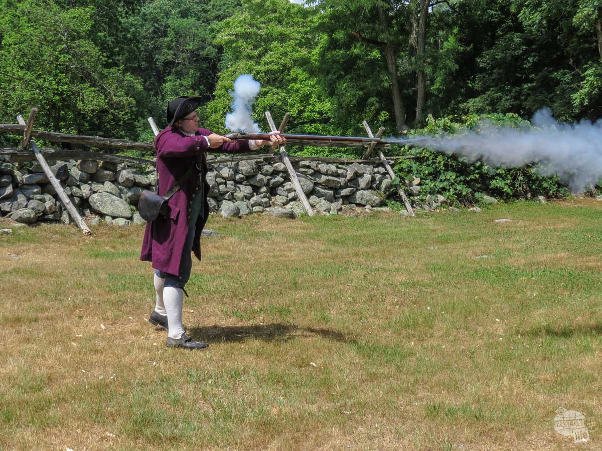 Dan, a living historian and volunteer for the Park Service, demonstrates how a musket used by the Colonial Militia would have worked.
