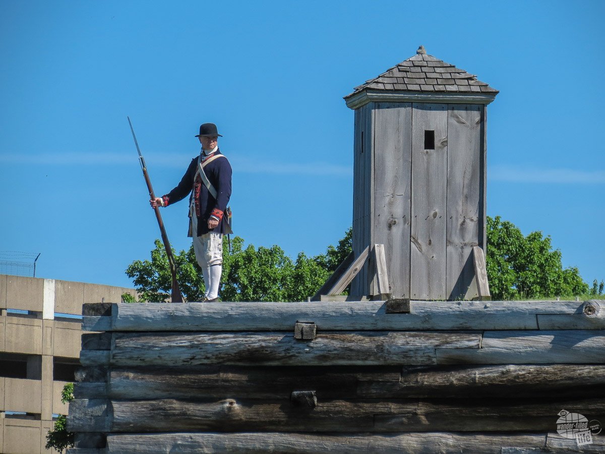 A park volunteer dressed as a colonial sentry stands watch.