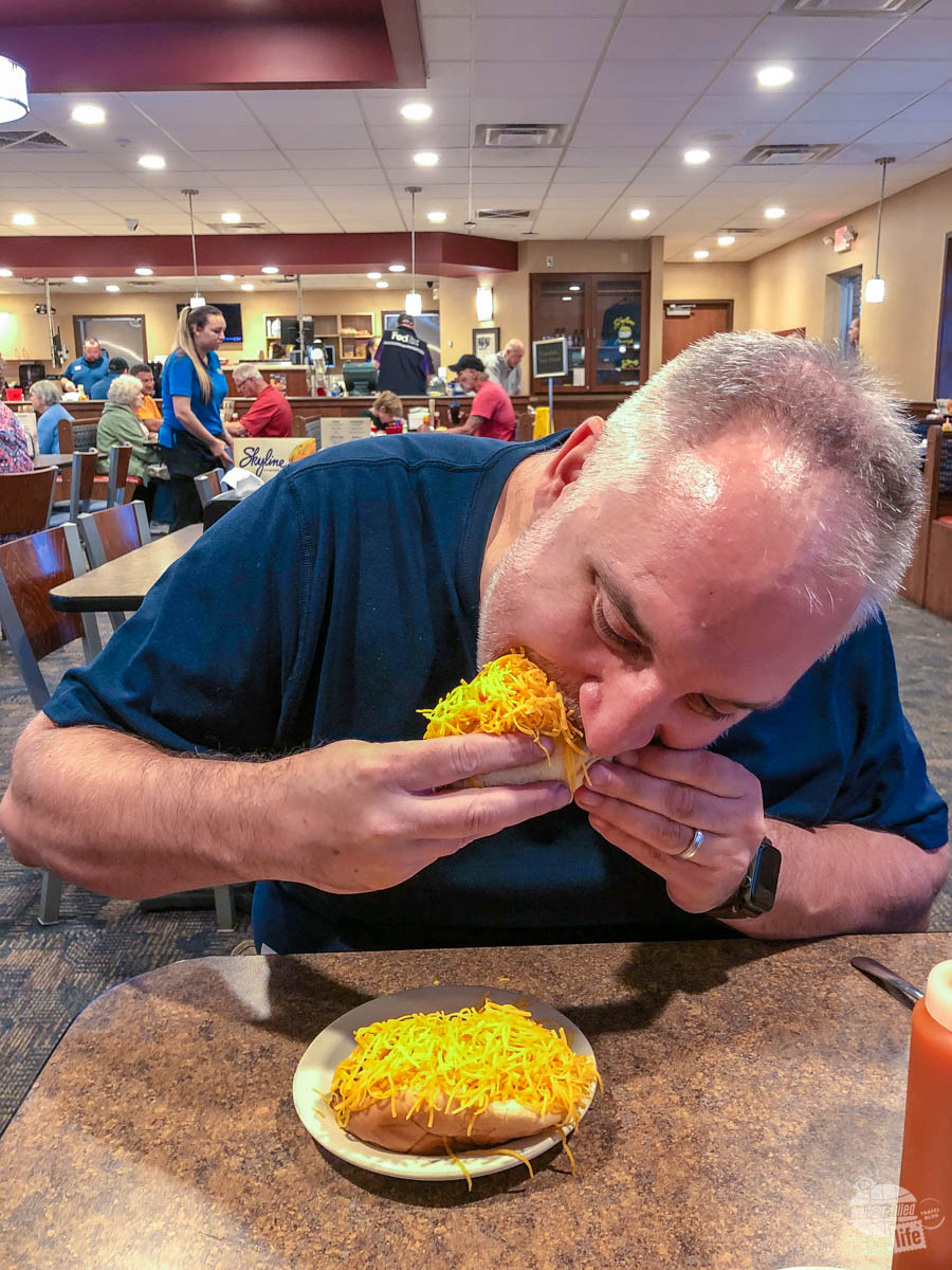Grant munching on a Coney at Skyline Chili.