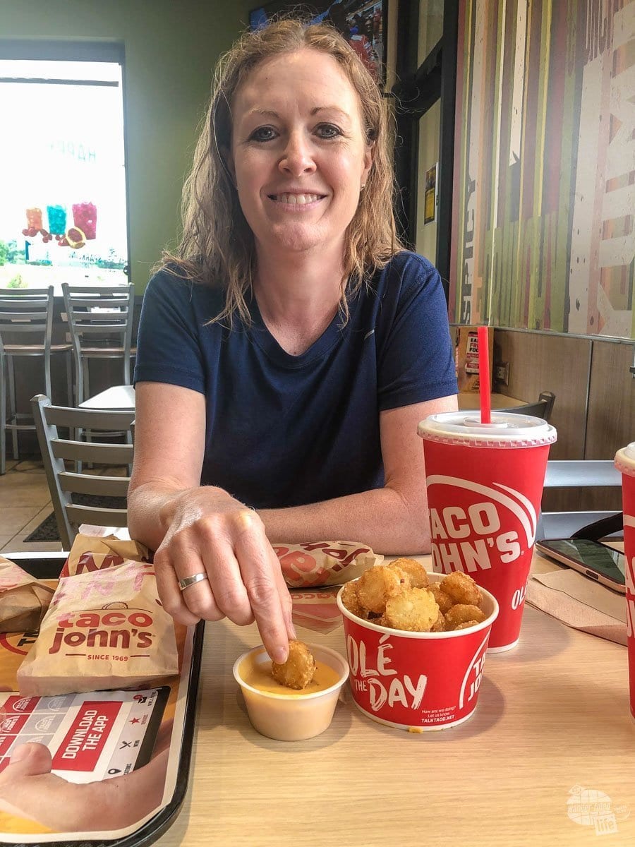 Bonnie dunking a potato ole at Taco John's, one of our favorite fast food joints.