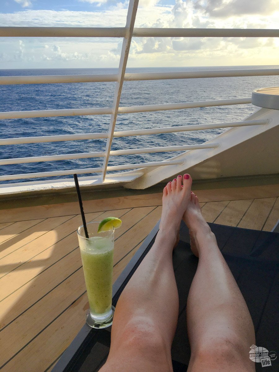 Bonnie enjoying a mojito on the balcony of the cabin 9690 on the Adventure of the Seas.