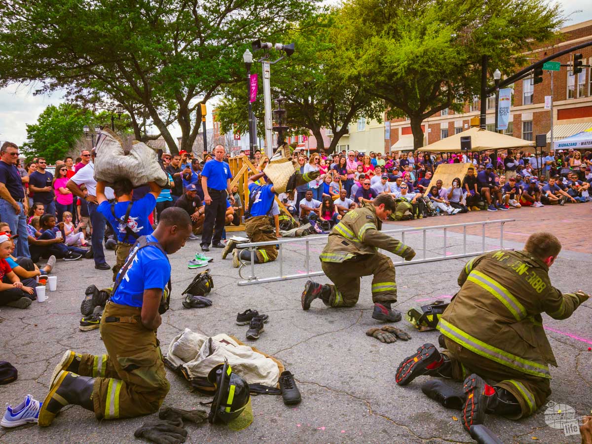 Members of the Macon-Bibb Fire Department hustle to put on their gear before running a relay.