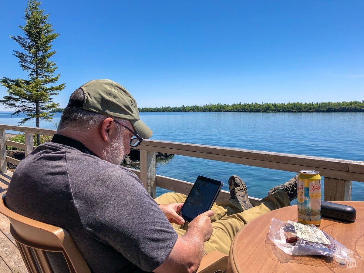 Grant enjoying a perfect lunch: a meat bites, a pint of beer, a good book and a great view.