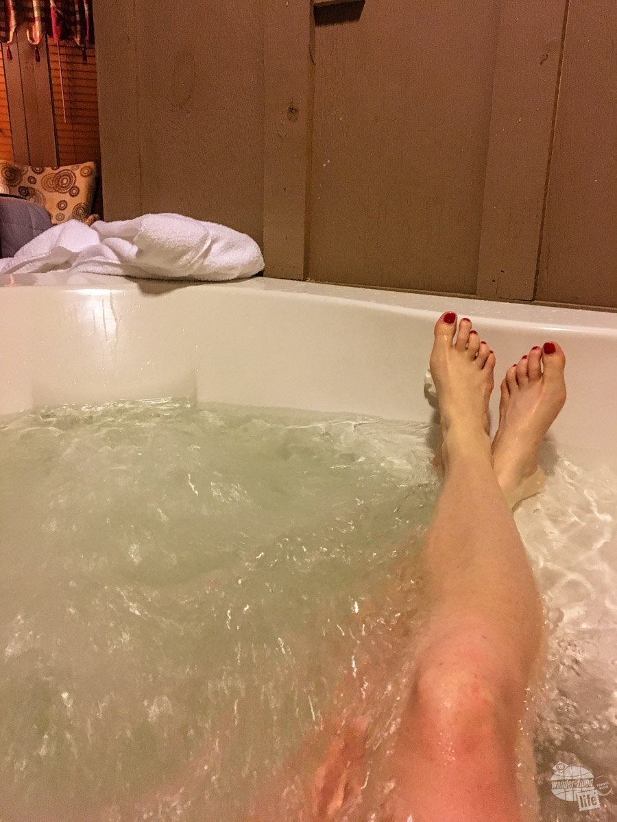 Bonnie relaxing in the Jacuzzi tub in our treehouse room at Historic Banning Mills.
