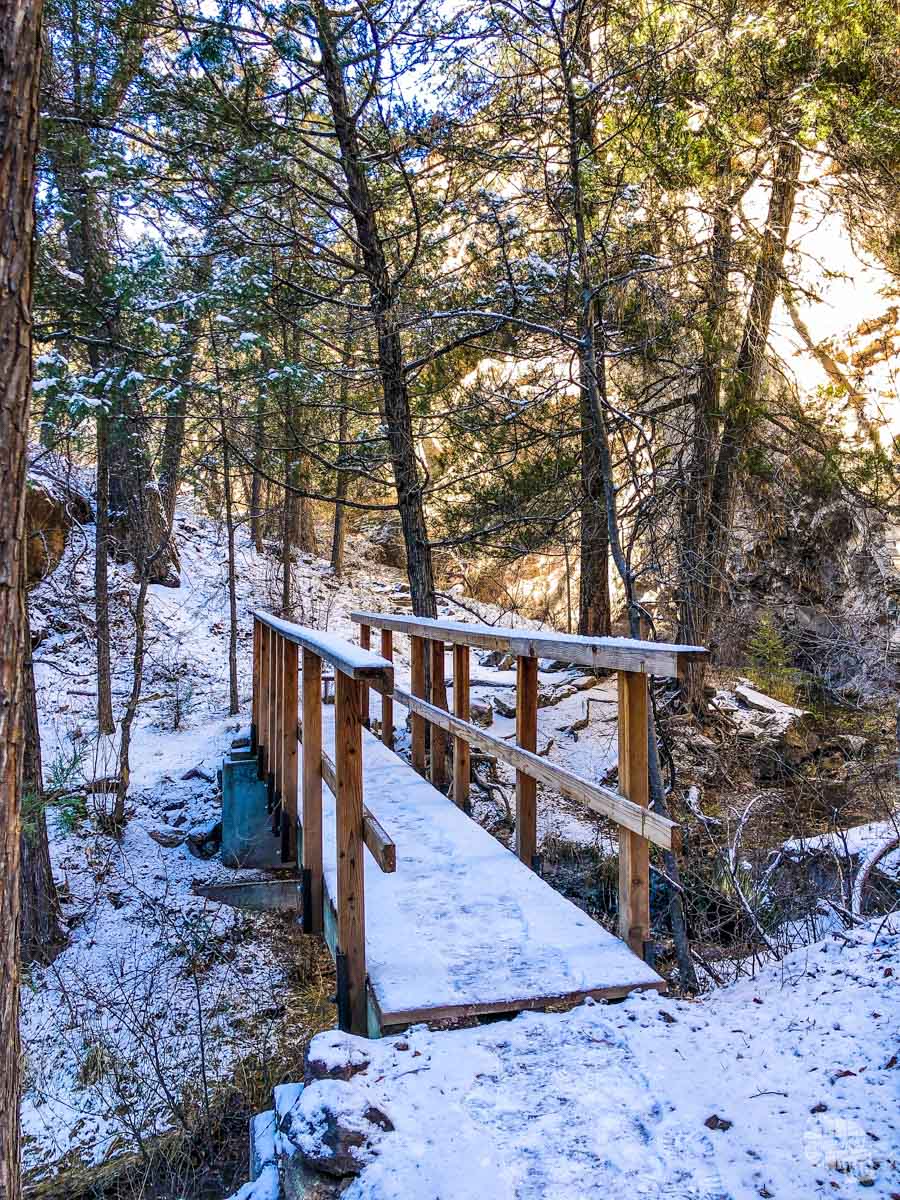 Snow-covered footbridge on the trail to the cliff dwellings.
