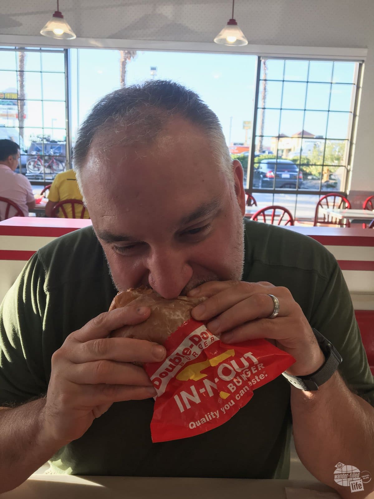 Grant biting into his first In-N-Out burger.