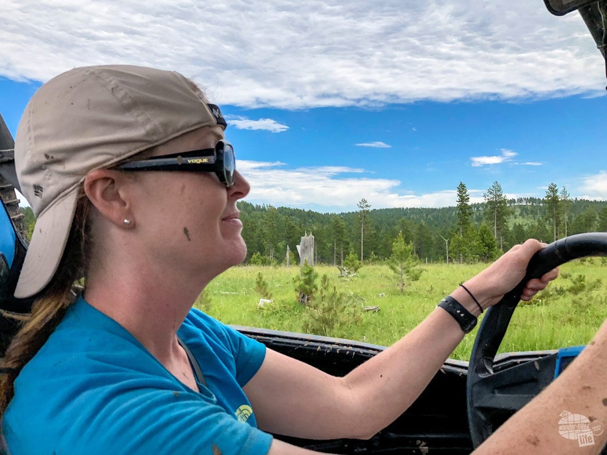 Bonnie drives the ATV in the Black Hills.