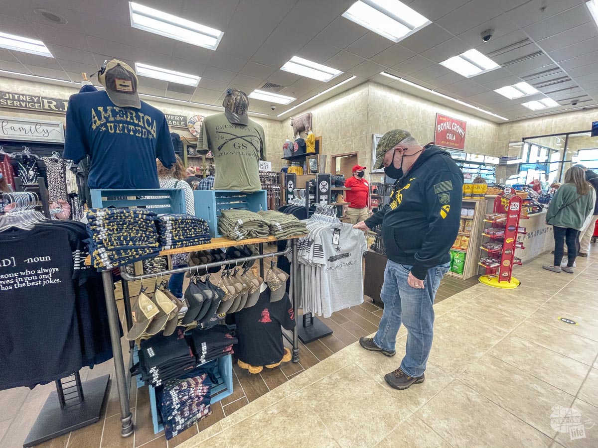 Grant shops for t-shirts at Buc-ee's.